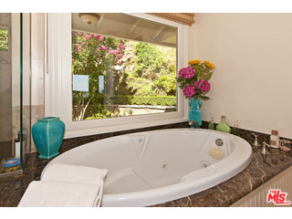 610 Estrellita Way Los Angeles, CA 90049 - Photo 26 of 53 a bath tub sitting in a bathroom next to a window