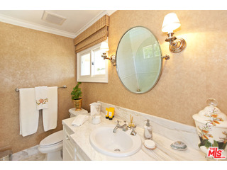610 Estrellita Way Los Angeles, CA 90049 - Photo 30 of 53 a bathroom with a sink mirror and vanity