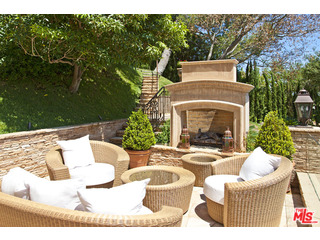 610 Estrellita Way Los Angeles, CA 90049 - Photo 36 of 53 a view of a patio with couches table and chairs and potted plants