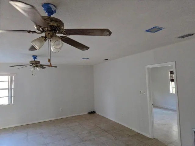 a kitchen with granite countertop a refrigerator stove and microwave