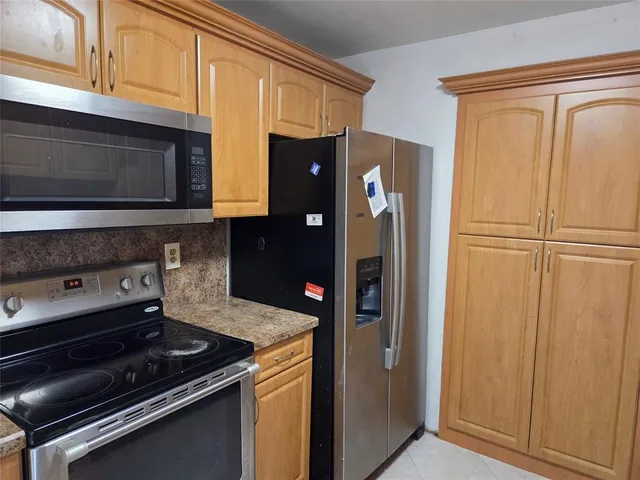 a kitchen with stainless steel appliances granite countertop a refrigerator sink and cabinets