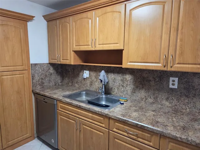a bathroom with a sink and a washer dryer