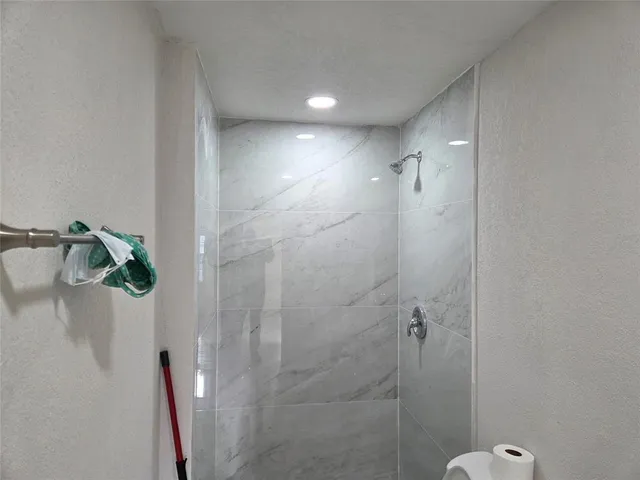 a bathroom with a toilet and shower