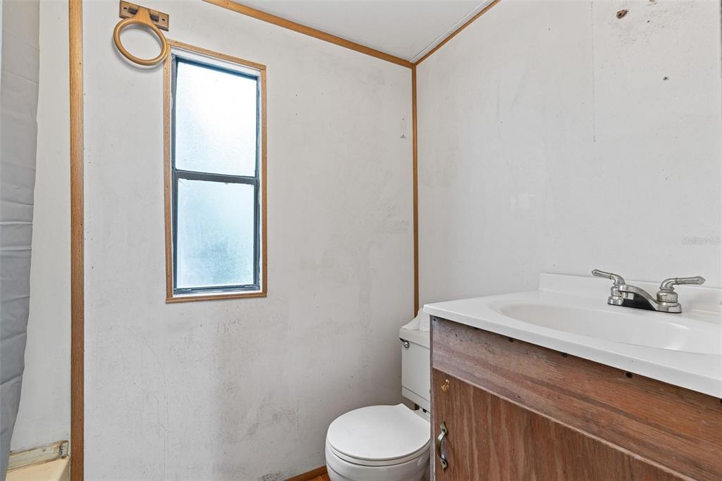 20072 Southeast 155th Place Umatilla, FL 32784 - Photo 11 of 30 a bathroom with a sink vanity mirror and toilet