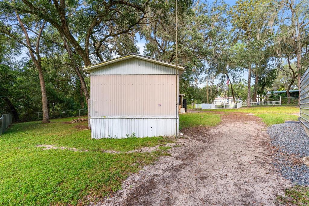 20072 Southeast 155th Place Umatilla, FL 32784 - Photo 16 of 30 a view of a house with a yard and large trees