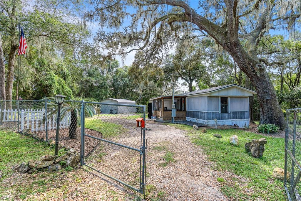 20072 Southeast 155th Place Umatilla, FL 32784 - Photo 21 of 30 a view of backyard with small cabin