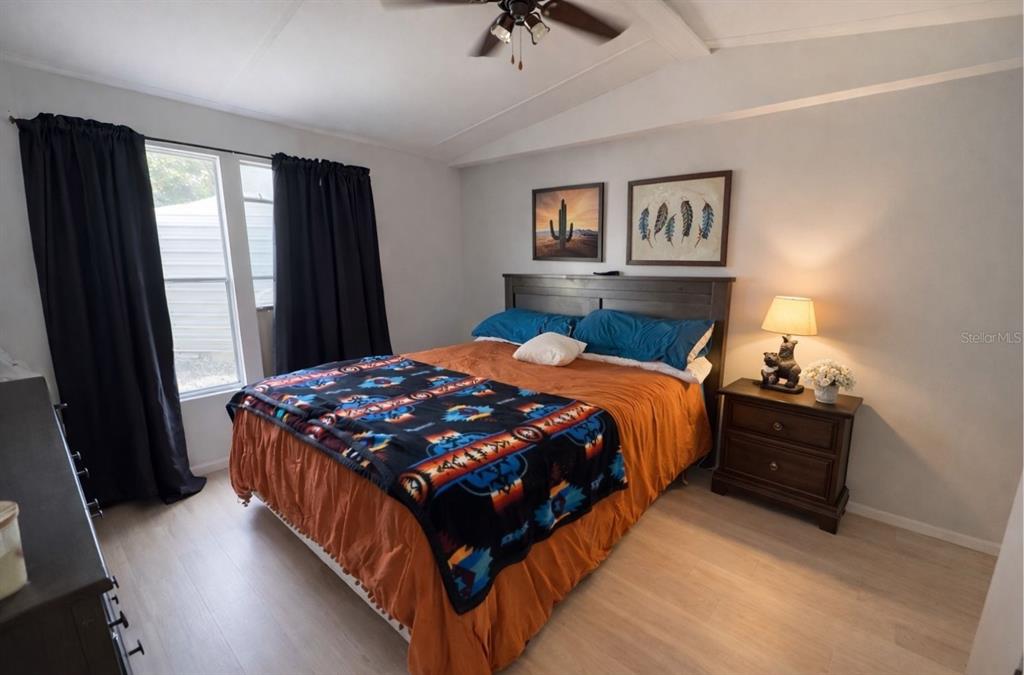 20072 Southeast 155th Place Umatilla, FL 32784 - Photo 6 of 30 a bedroom with a bed and painting on the wall