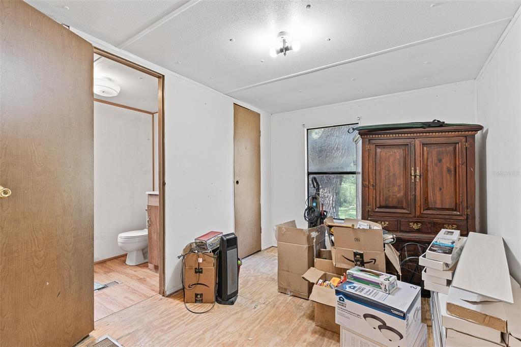 20072 Southeast 155th Place Umatilla, FL 32784 - Photo 7 of 30 a living room with furniture a mirror and a toilet