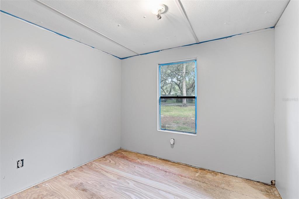 20072 Southeast 155th Place Umatilla, FL 32784 - Photo 10 of 30 a view of an empty room with wooden floor and a window