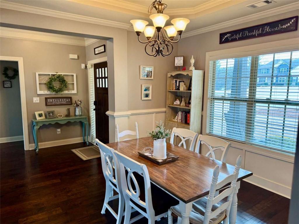 107 Feather Lane Jackson, GA 30233 - Photo 11 of 30 a view of a dining room with furniture a chandelier and wooden floor