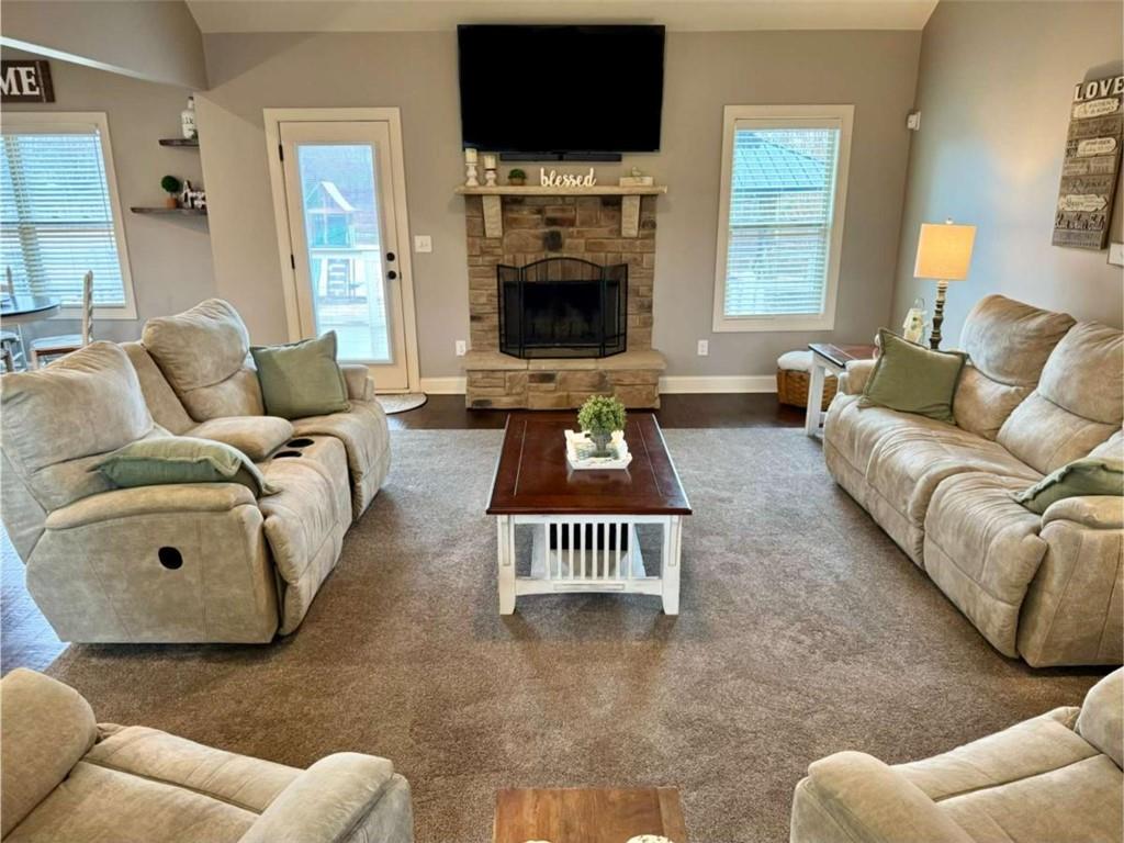 107 Feather Lane Jackson, GA 30233 - Photo 12 of 30 a living room with furniture a flat screen tv and a fireplace