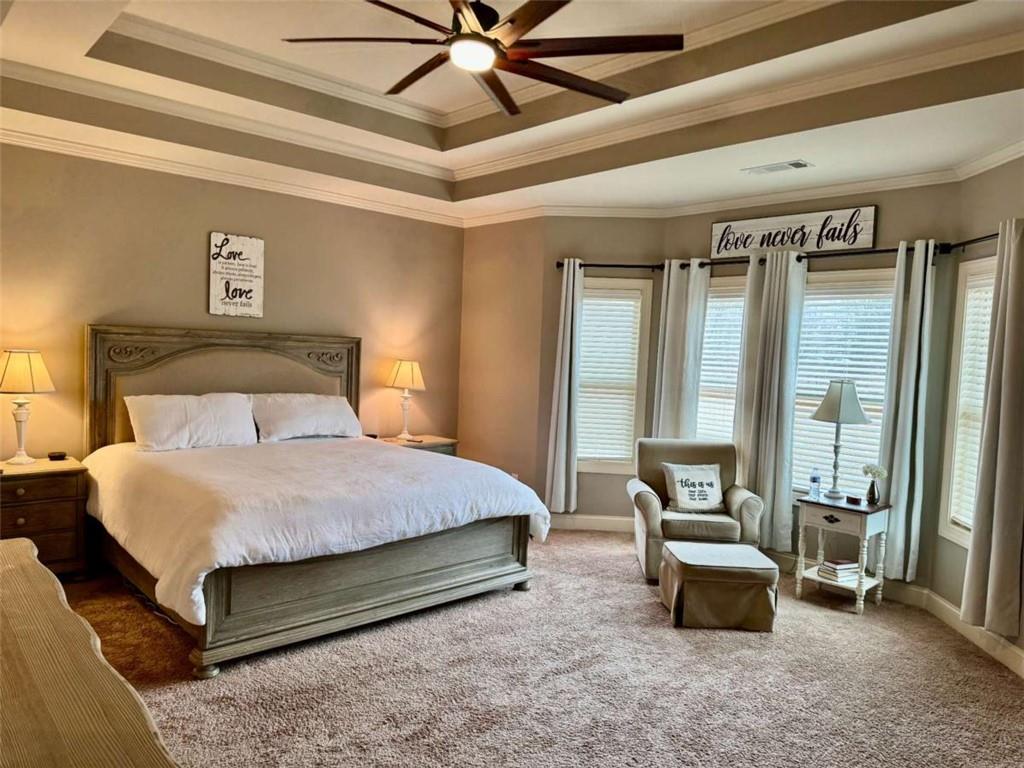 107 Feather Lane Jackson, GA 30233 - Photo 15 of 30 a bedroom with a bed and a chandelier