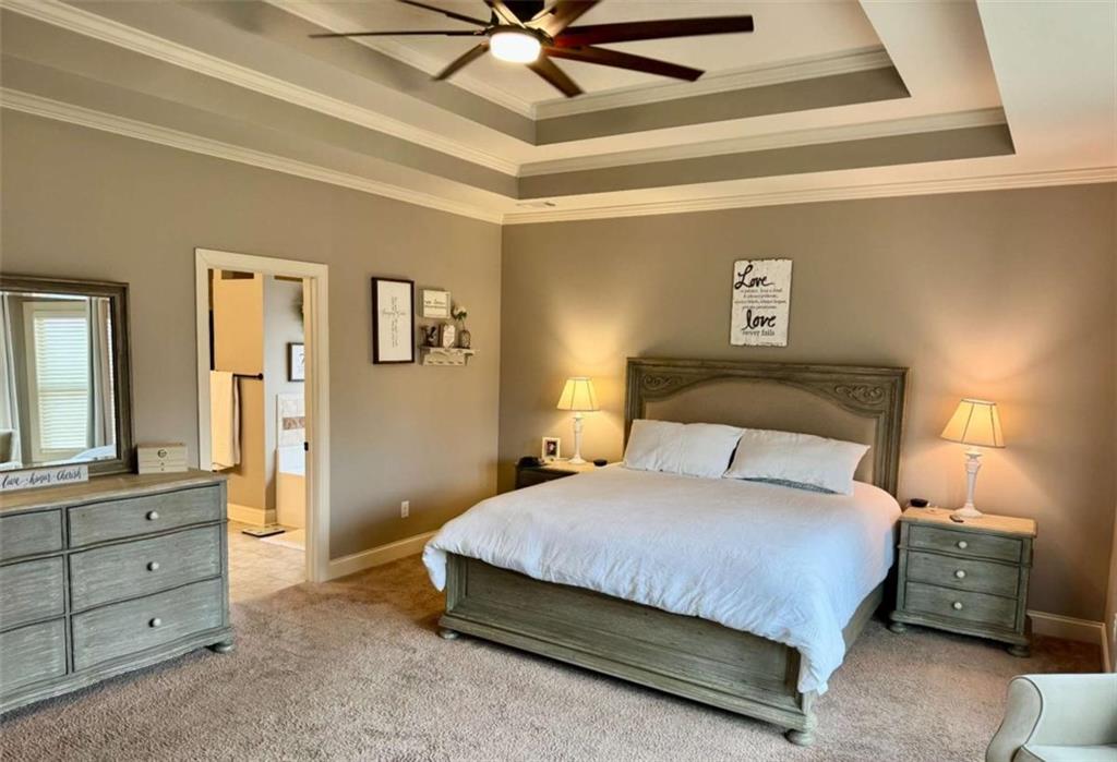 107 Feather Lane Jackson, GA 30233 - Photo 16 of 30 a bedroom with a bed and a chandelier