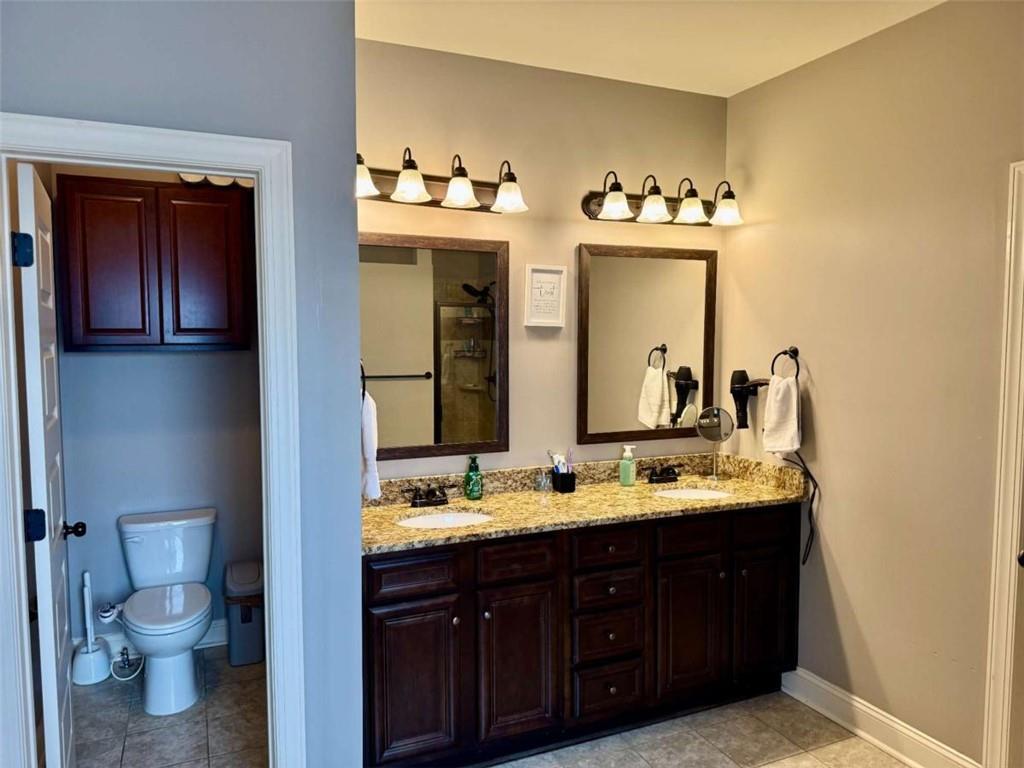 107 Feather Lane Jackson, GA 30233 - Photo 19 of 30 a bathroom with a double vanity sink and a mirror