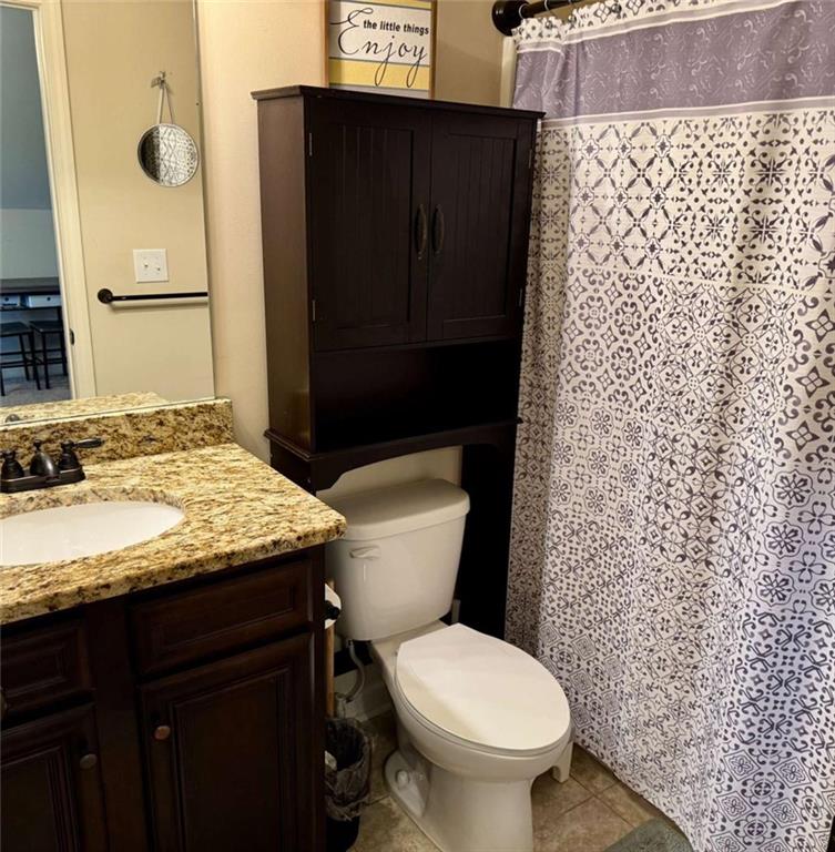 107 Feather Lane Jackson, GA 30233 - Photo 25 of 30 a bathroom with a granite countertop toilet and a sink