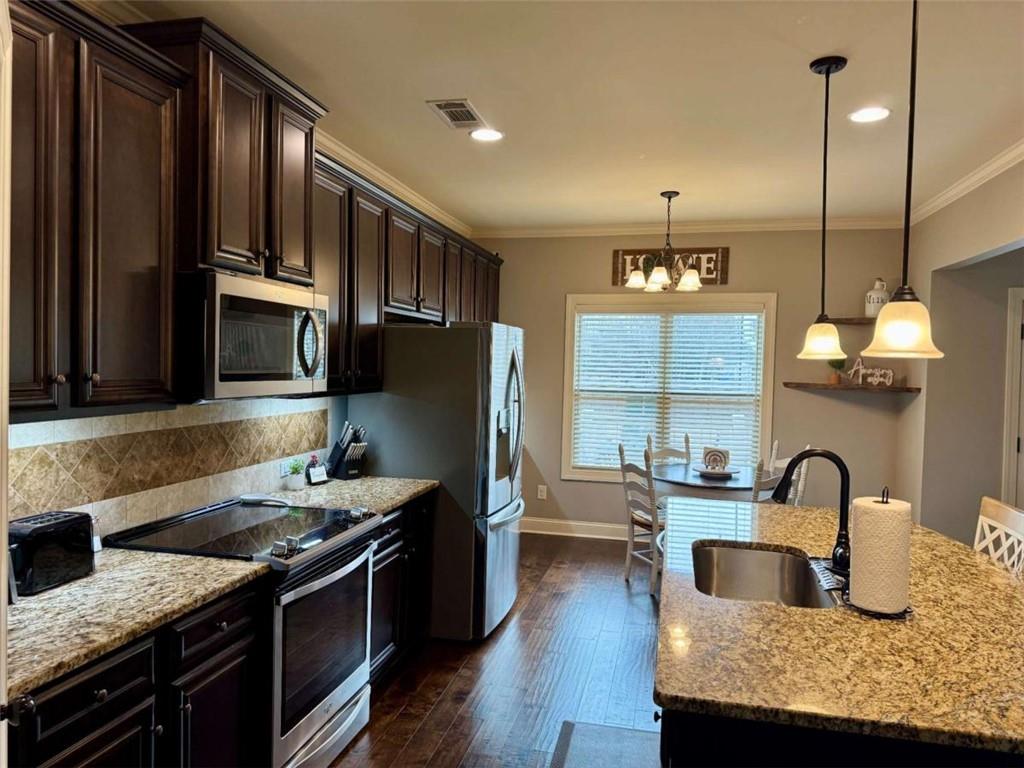 107 Feather Lane Jackson, GA 30233 - Photo 7 of 30 a kitchen with granite countertop a stove and a refrigerator