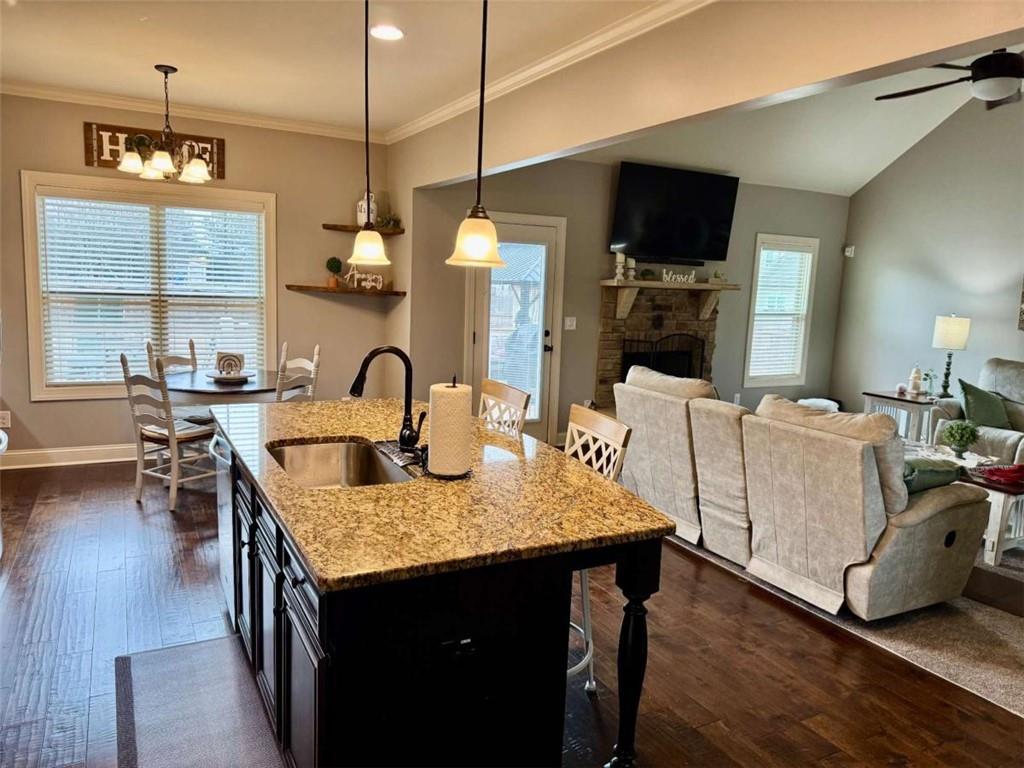 107 Feather Lane Jackson, GA 30233 - Photo 9 of 30 a living room with furniture a flat screen tv and kitchen view