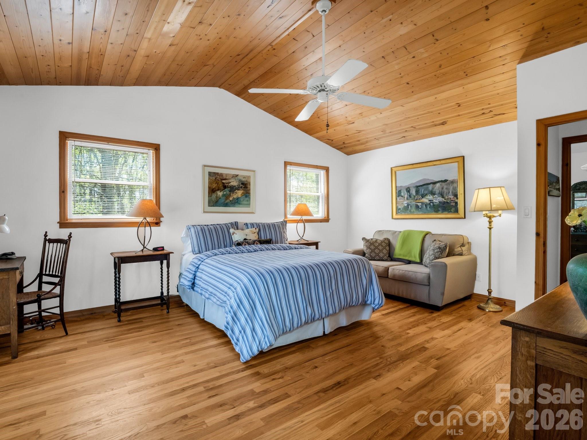 780 Rixhaven Drive Saluda, NC 28773 - Photo 18 of 36 a spacious bedroom with a bed and wooden floor