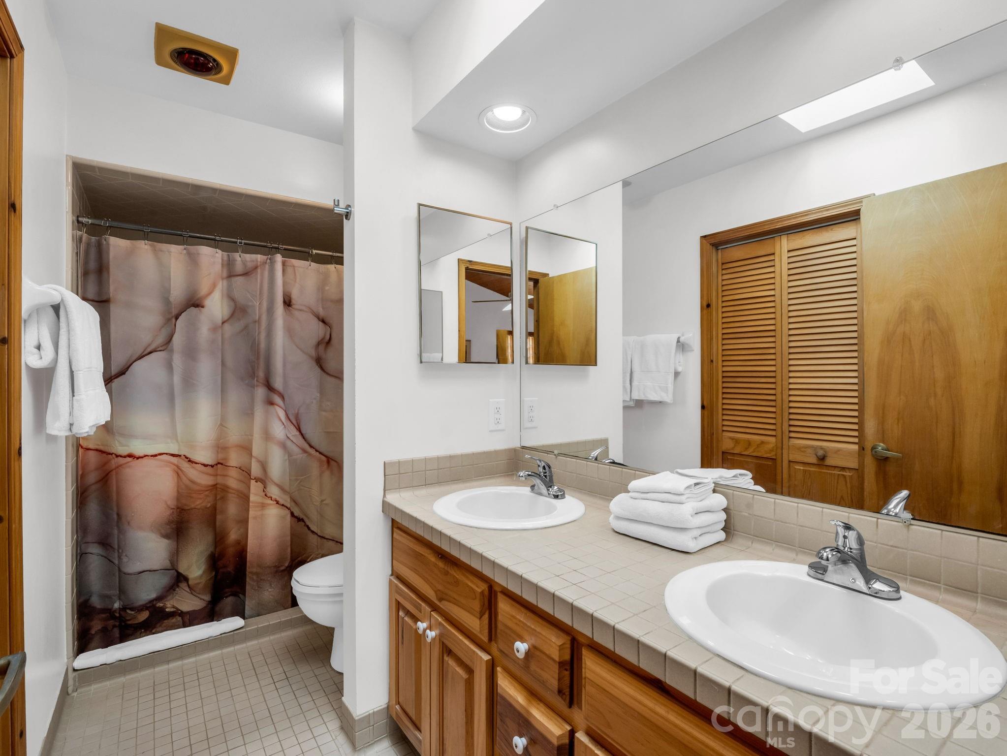 780 Rixhaven Drive Saluda, NC 28773 - Photo 21 of 36 a bathroom with a double vanity sink mirror and toilet