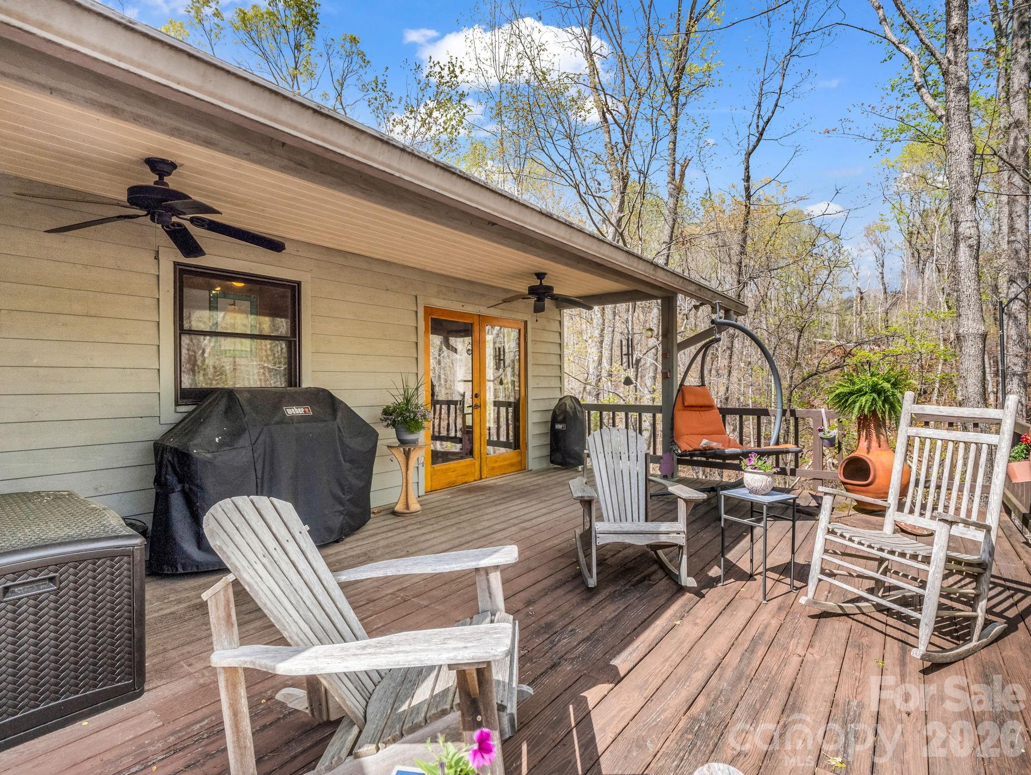 780 Rixhaven Drive Saluda, NC 28773 - Photo 28 of 36 a view of a patio with couches table and chairs and wooden floor