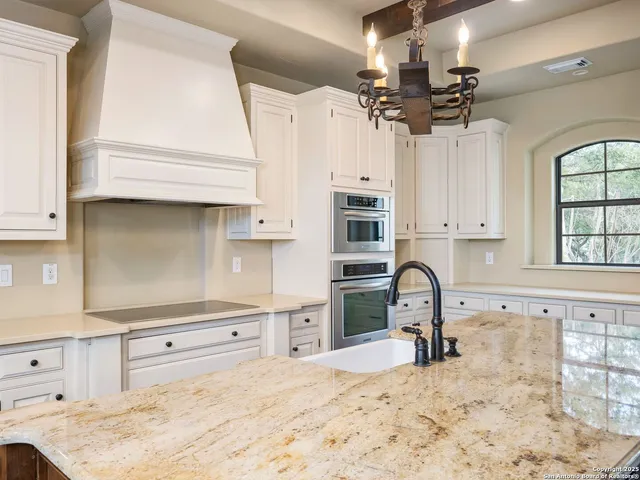 a spacious bathroom with double vanity a mirror a vanity and a bathtub