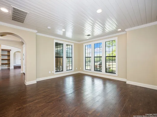 an empty room with fan and entryway