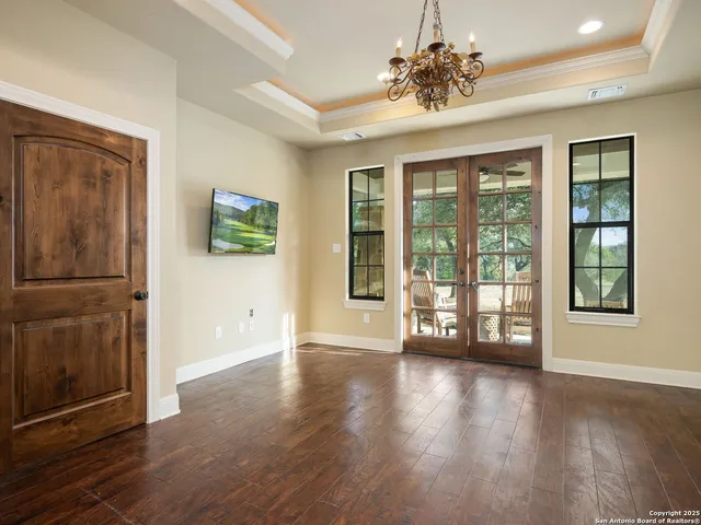 a bathroom with a sink a large mirror and a bathtub next to a window