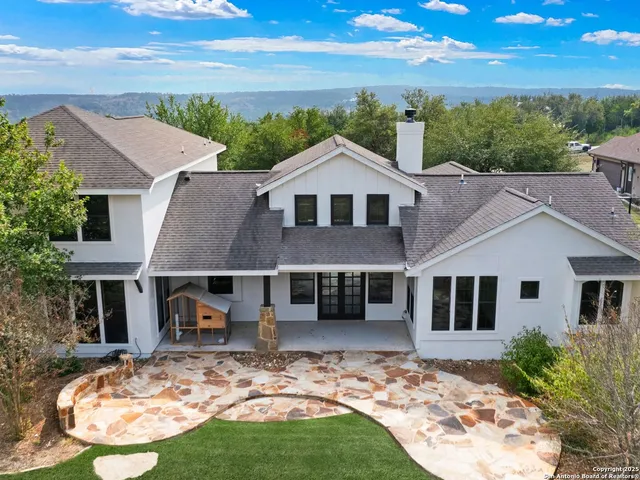an aerial view of residential houses with city view