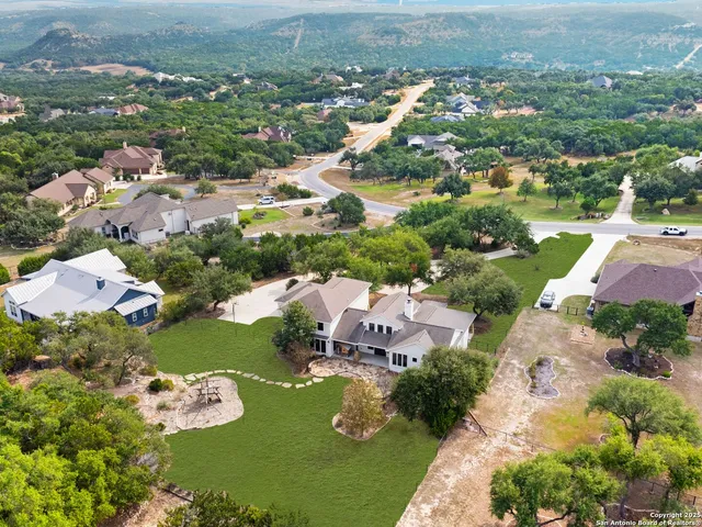 an aerial view of a house with a yard