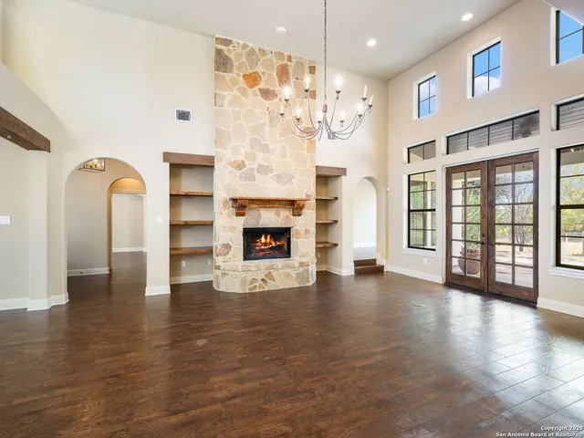 a view of an empty room with window and fireplace