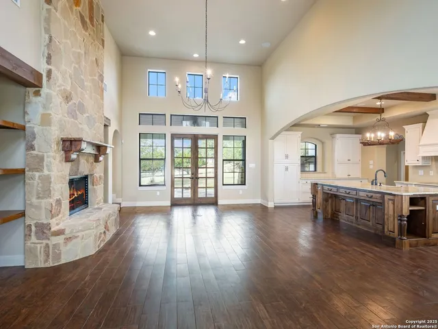 an open kitchen with a sink and breakfast area
