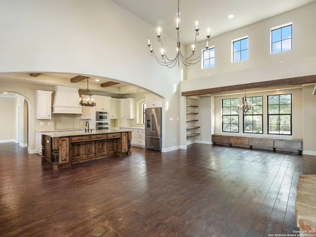 an empty room with wooden floor and window
