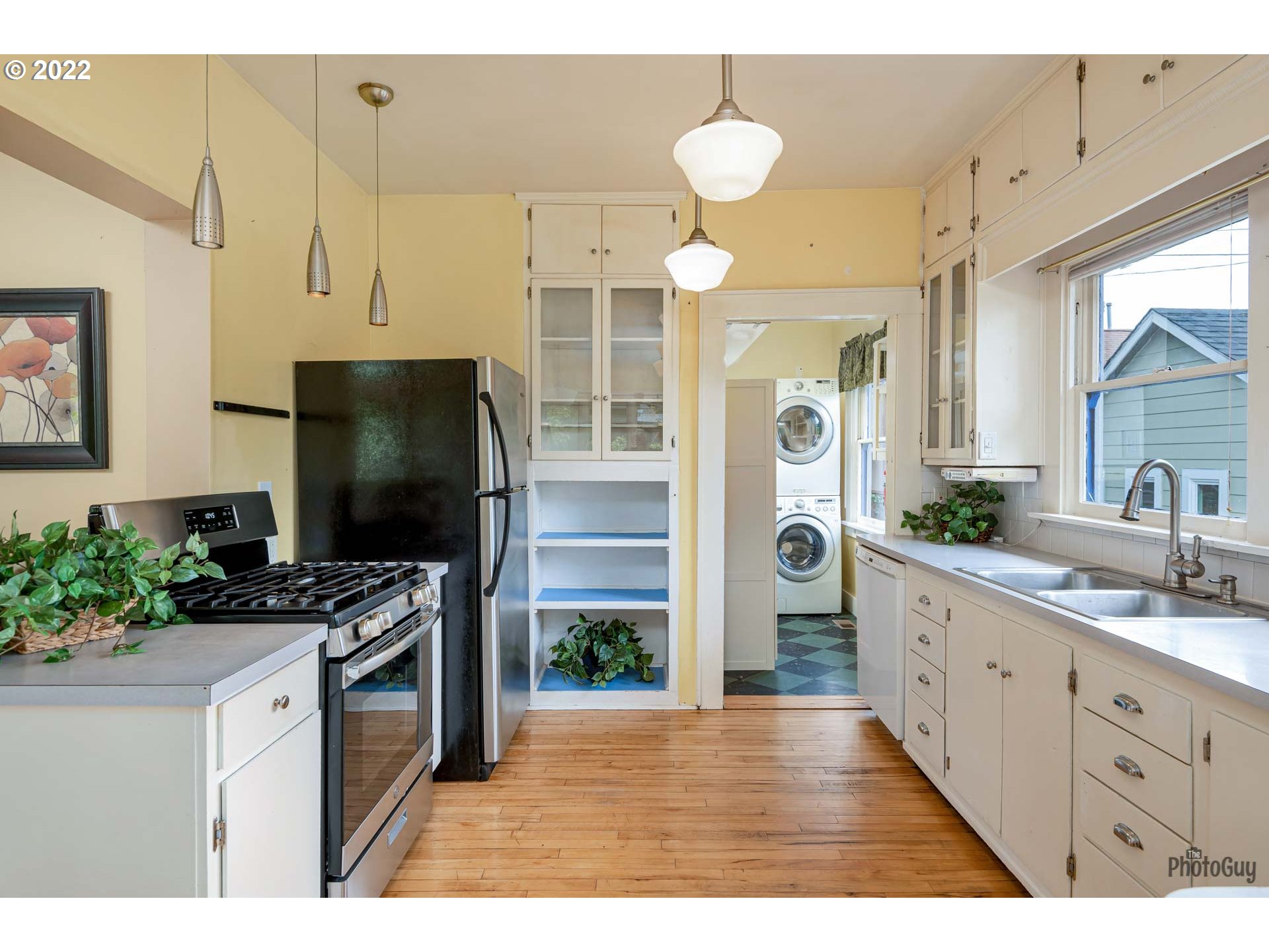 346 D Street Springfield, OR 97477 - Photo 14 of 32 a kitchen with stainless steel appliances kitchen island granite countertop a refrigerator a sink and a stove