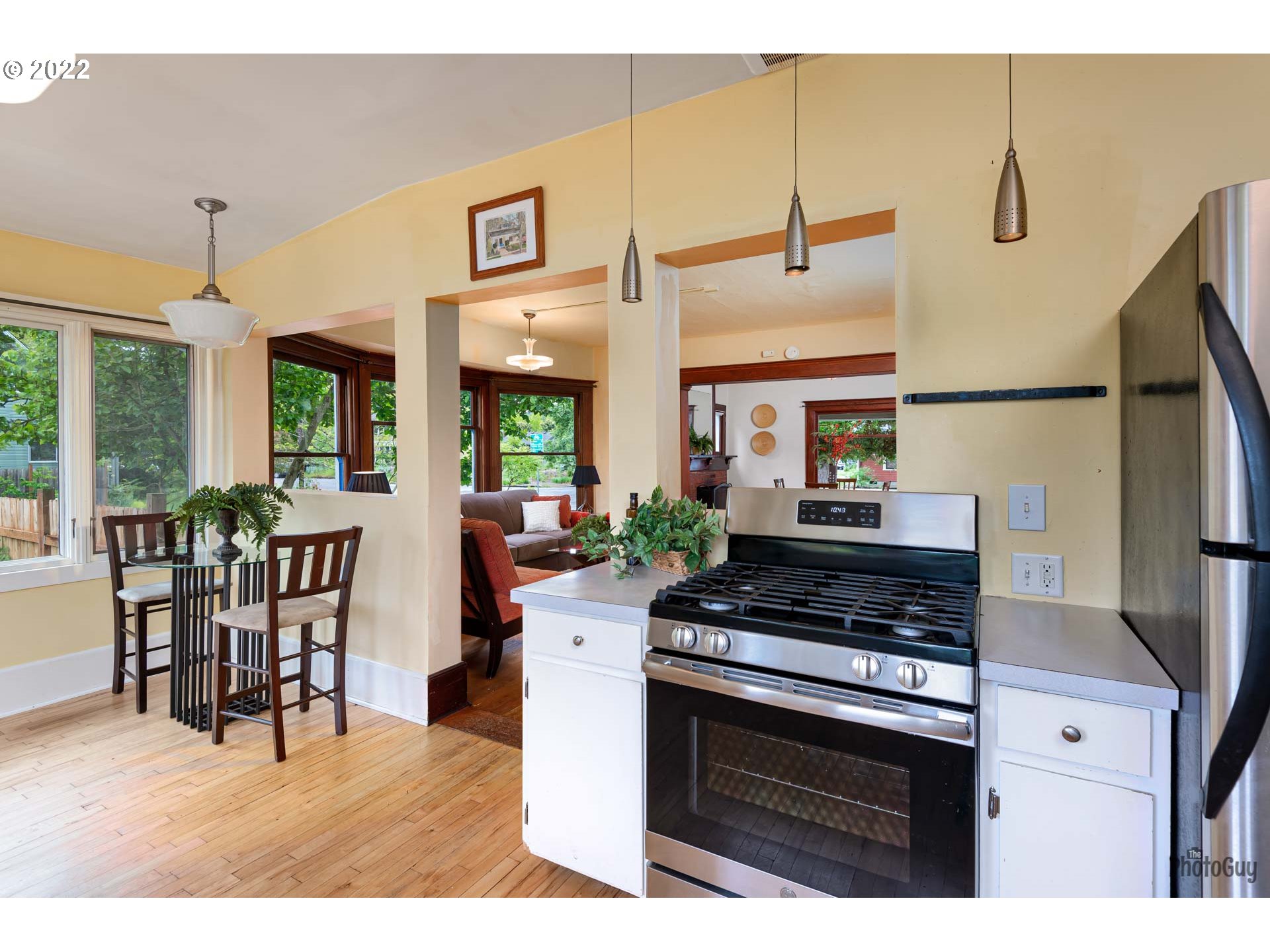 346 D Street Springfield, OR 97477 - Photo 15 of 32 a kitchen with stainless steel appliances kitchen island a stove a sink a dining table and chairs