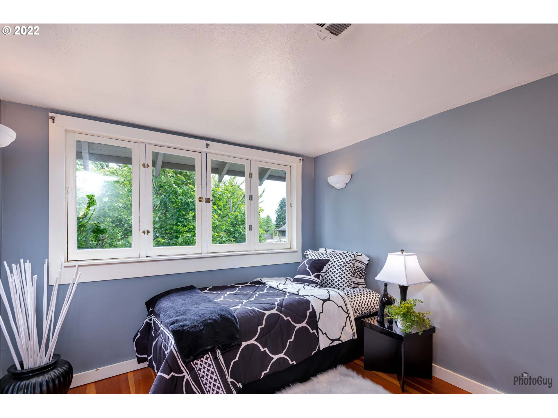 346 D Street Springfield, OR 97477 - Photo 26 of 32 a bedroom with a bed lamps and window