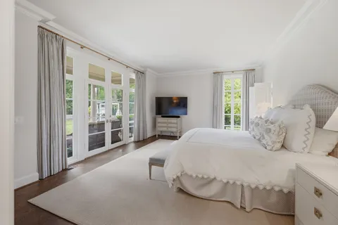 a spacious bedroom with a bed and a window