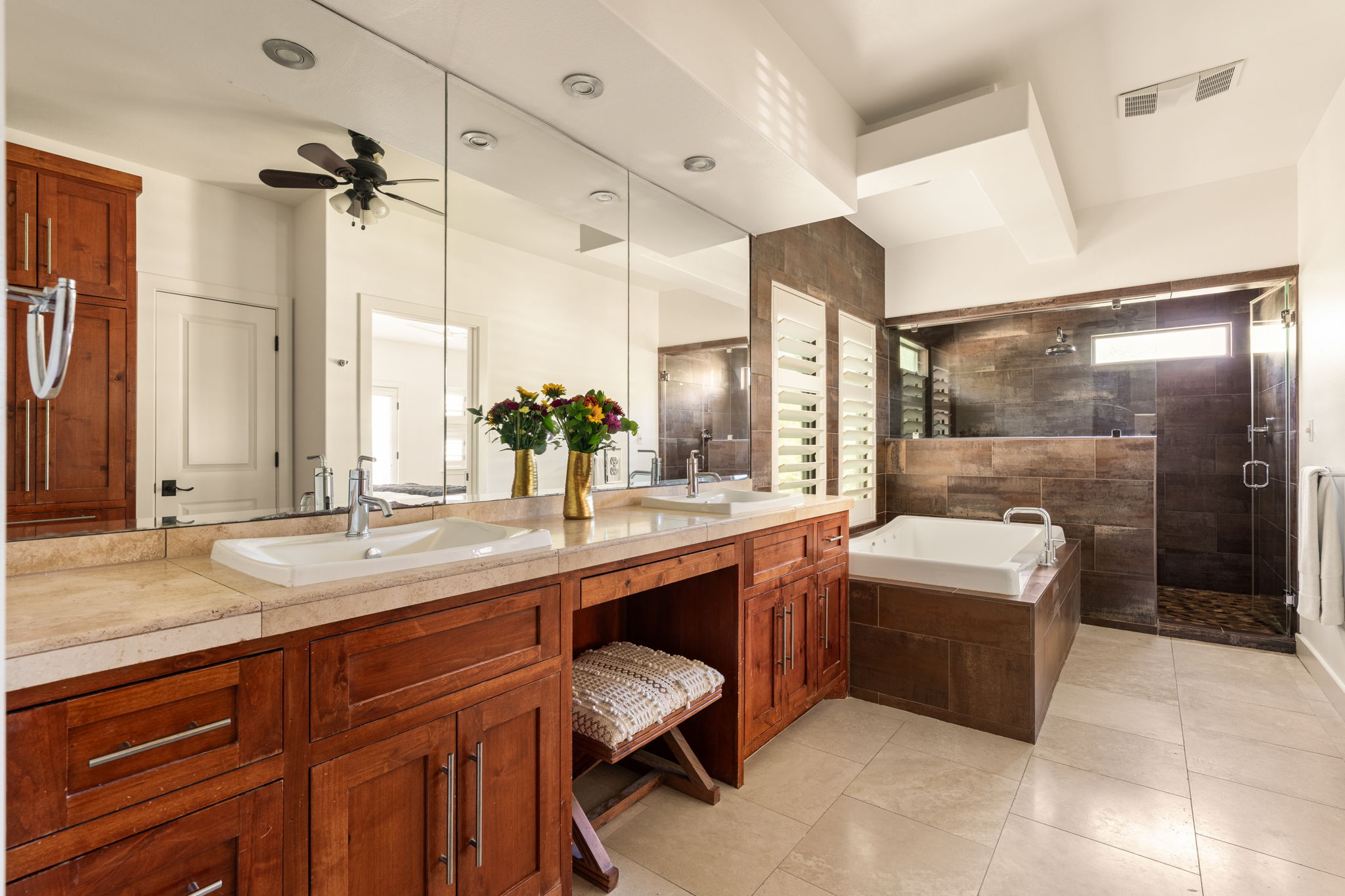 2324 Kinney Road Austin, TX 78704 - Photo 20 of 35 Rich wood cabinetry and a deep soaking tub highlight this beautifully tiled bathroom space.