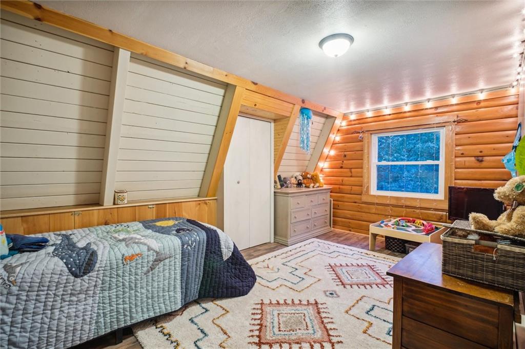 167 Wilkinson Road Templeton, PA 16259 - Photo 30 of 49 a bedroom with a bed and wooden floor