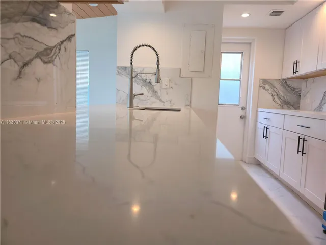 a view of a kitchen with a sink and dishwasher