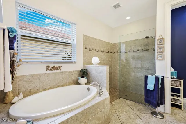 a bathroom with a tub and a shower