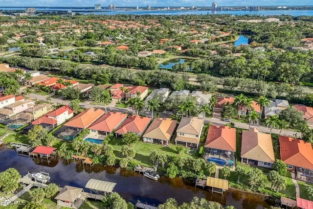 an aerial view of a houses with yard and outdoor seating