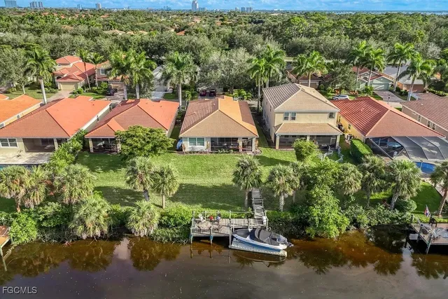 an aerial view of residential houses with outdoor space and street view