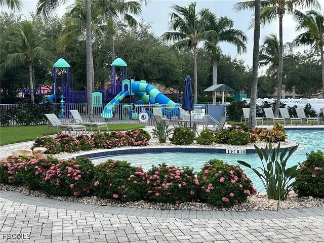 a room with pool table and windows