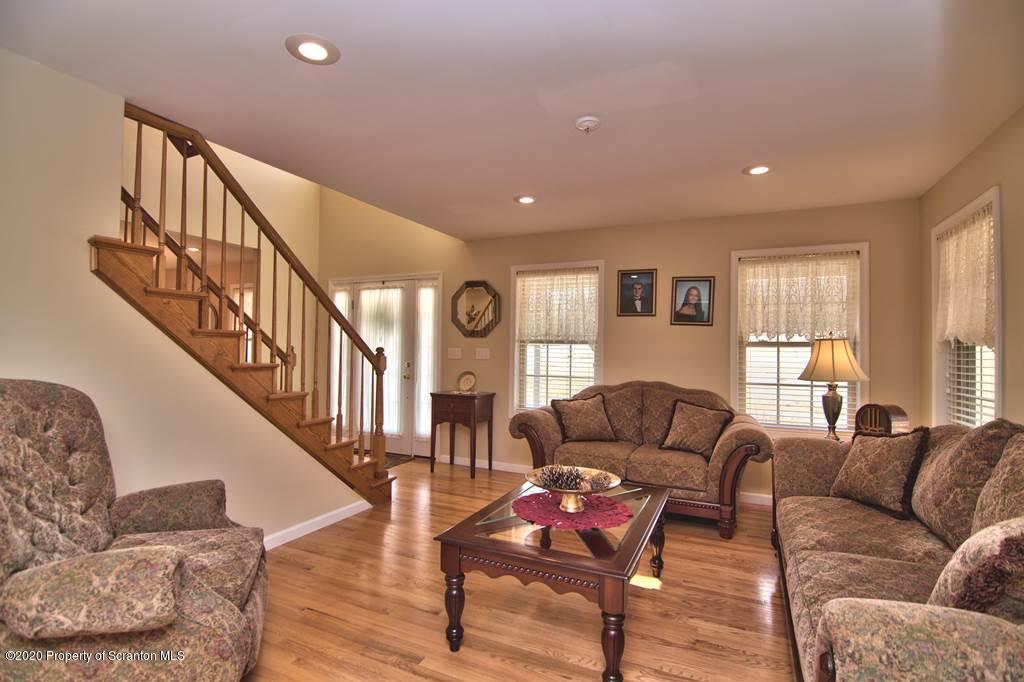 521 Summit Woods Road Moscow, PA 18444 - Photo 11 of 77 a living room with furniture and a wooden floor