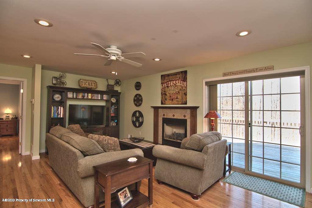 521 Summit Woods Road Moscow, PA 18444 - Photo 14 of 77 a living room with furniture and a fireplace