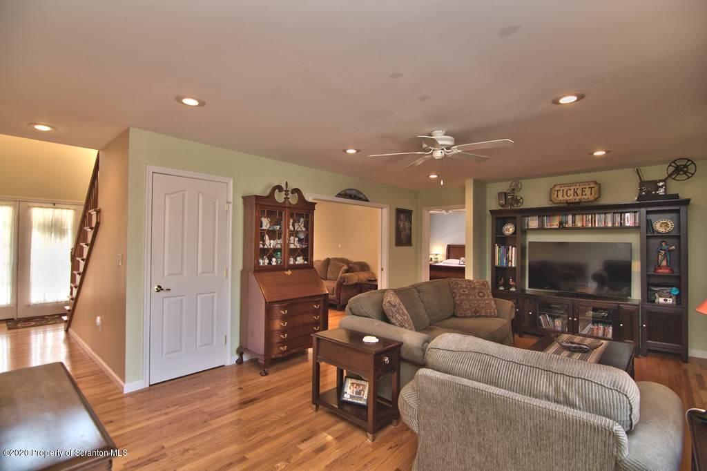 521 Summit Woods Road Moscow, PA 18444 - Photo 15 of 77 a living room with furniture and a fireplace