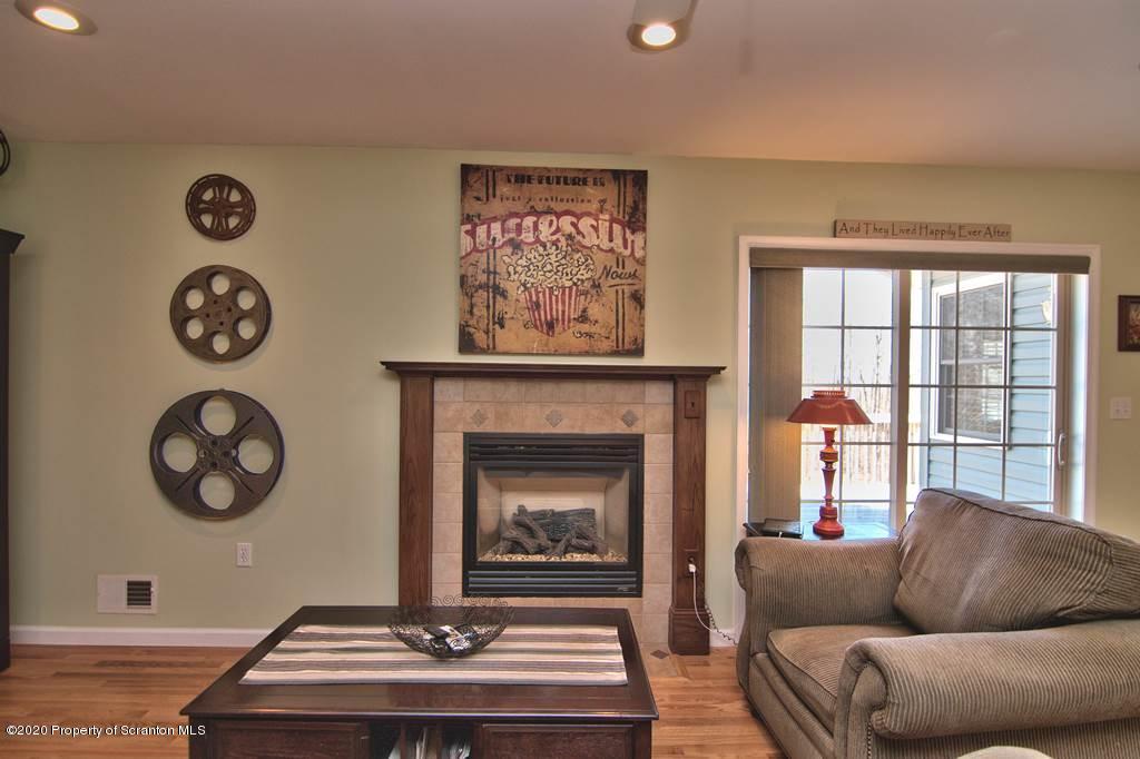 521 Summit Woods Road Moscow, PA 18444 - Photo 16 of 77 a living room with furniture and a fireplace