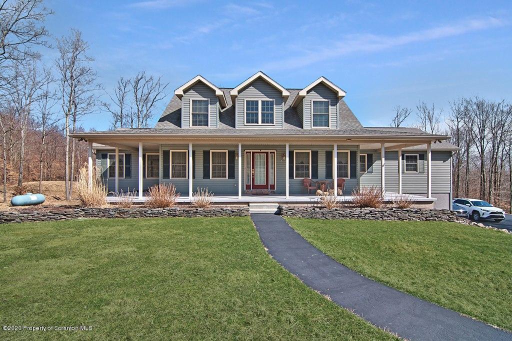 521 Summit Woods Road Moscow, PA 18444 - Photo 2 of 77 front view of a house with a yard