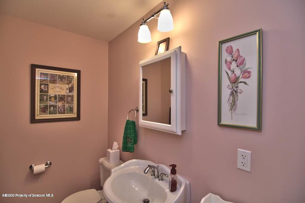 521 Summit Woods Road Moscow, PA 18444 - Photo 29 of 77 a bathroom with a sink mirror and vanity