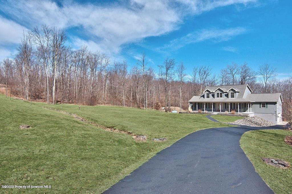521 Summit Woods Road Moscow, PA 18444 - Photo 3 of 77 a view of a house with a big yard and large trees